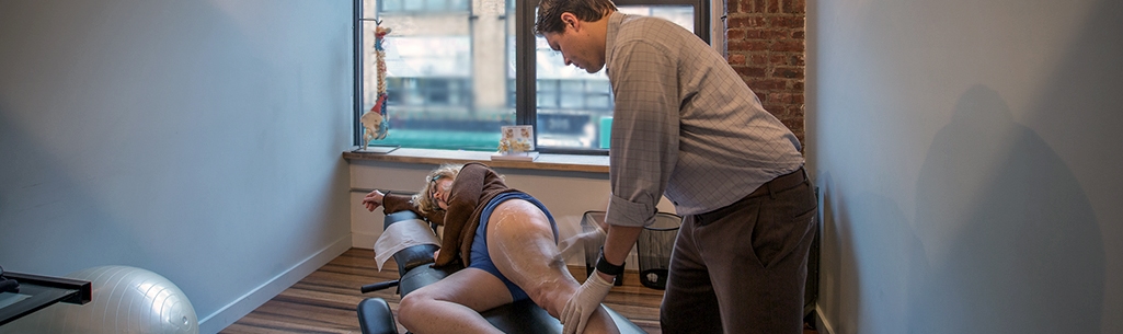 Chiropractor Dr. Stephen Szaro performing the Graston Technique on a patient.