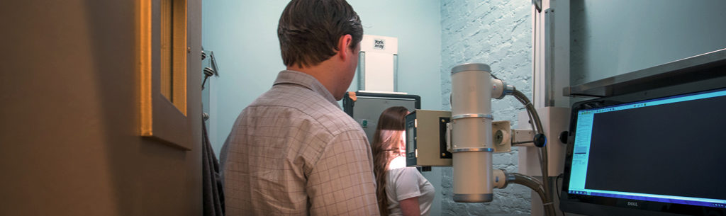 Chiropractor Dr. Stephen Szaro taking x-rays or patient.